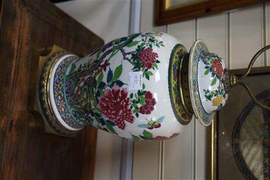 A pair of large Chinese famille rose baluster jars and covers, late 19th / early 20th century, 80.5cm to top of brass fittings